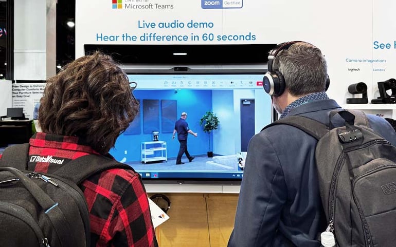 Two InfoComm attendees get a demo of Nureva's full-room mic pickup and automated camera switching